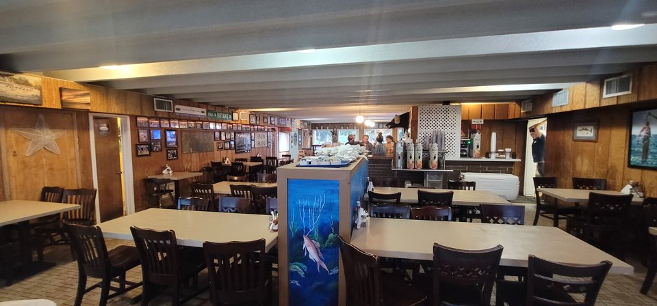 Seafood plates beside a waterfront dining room.
